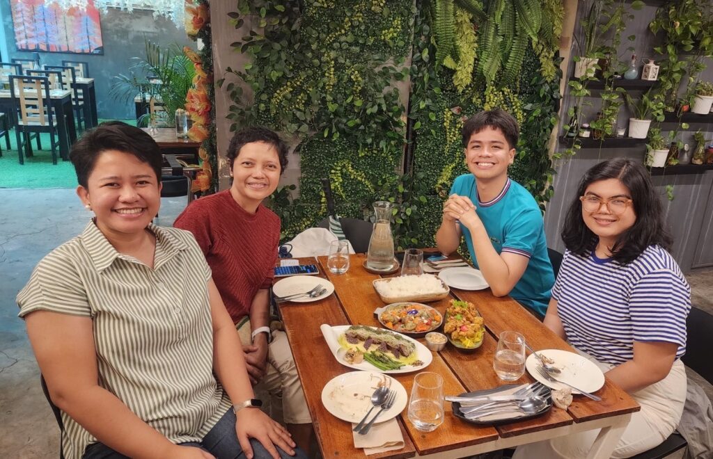 Group dining with food on table.